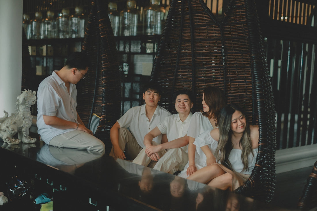 Family in white outfits relaxing together indoors.